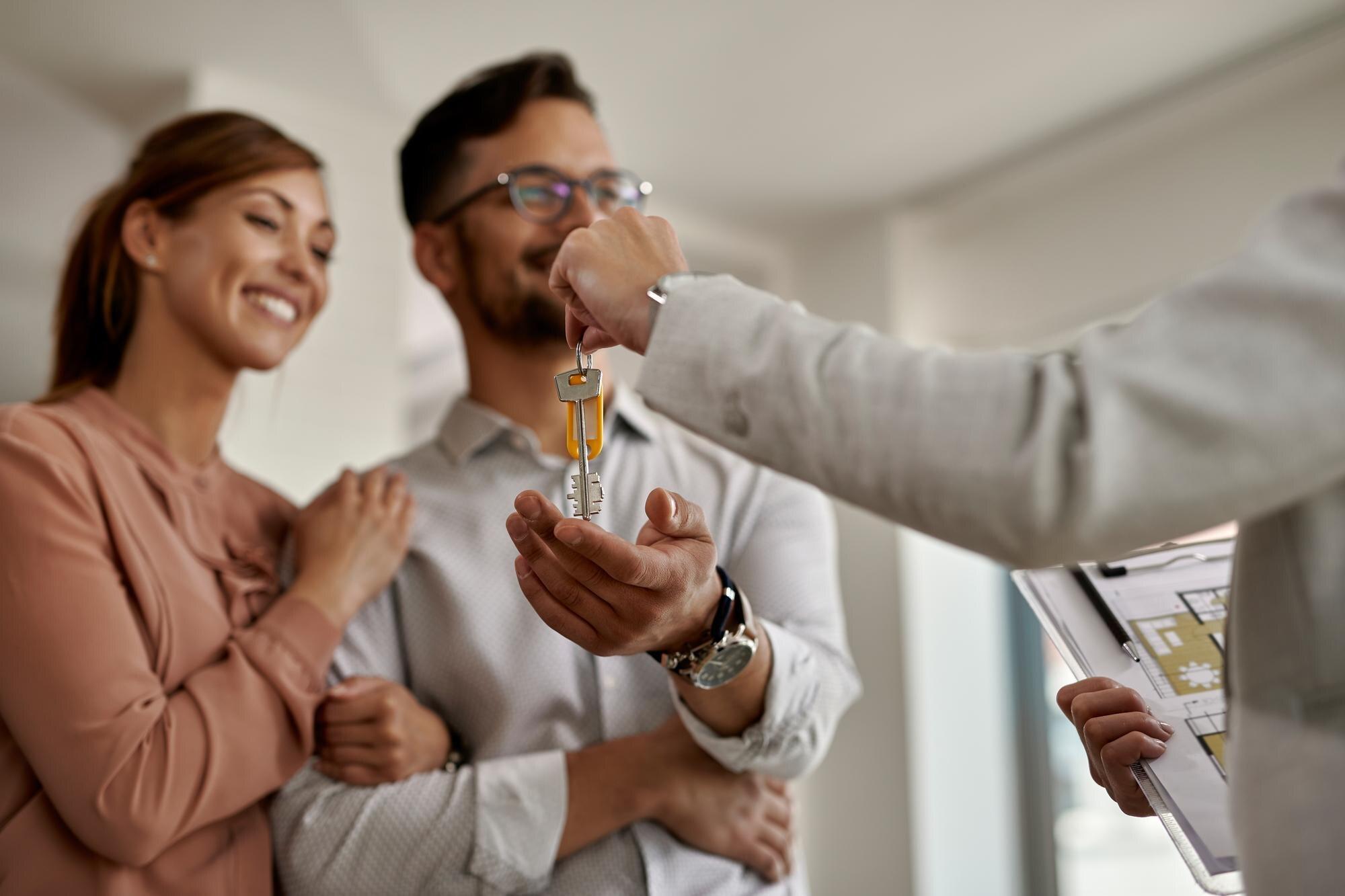 A couple receiving the keys to a home